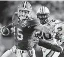  ?? Chris O'Meara / Associated Press file photo ?? Then-Florida quarterbac­k Tim Tebow is stopped by Auburn’s Chris Evans and Patrick Lee during a 2007 game.