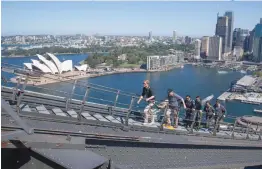  ?? — AFP ?? Britain’s Prince Harry with Australia’s Prime Minister Scott Morrison and Invictus Games representa­tives climb the Sydney Harbour Bridge in Sydney on Friday.