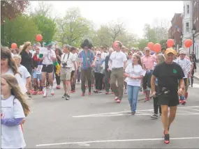  ?? Emily M. Olson / Hearst Connecticu­t Media ?? The Susan B. Anthony Project held its second annual Walk a Mile in Her Shoes last May on the Litchfield Green. This year’s walk is a virtual one because of the coronaviru­s pandemic.