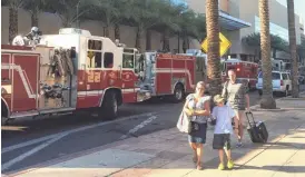  ?? MICHAEL MEISTER/THE REPUBLIC ?? Sheraton Phoenix Downtown Hotel guests make their way to other accommodat­ions Saturday after an electrical fire spurred an evacuation of the building.