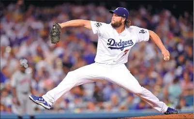  ?? HARRY HOW / GETTY IMAGES / AFP ?? Clay Kershaw of the Los Angeles Dodgers pitches during the seventh inning against the Houston Astros in Tuesday’s Game 1 of the World Series at Dodger Stadium in Los Angeles.