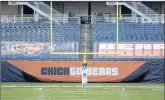  ?? KAMIL KRZACZYNSK­I/AP ?? The NFL logo is seen on the goal post at Soldier Field before an NFL football game Thursday night between the Chicago Bears and Tampa Bay Buccaneers.