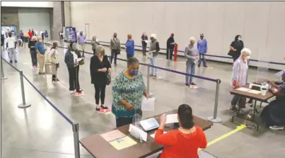  ?? The Sentinel-Record/Richard Rasmussen ?? IN LINE: Voters wait in line to vote at the Hot Springs Convention Center Monday during the first day of early voting for the Nov. 3 general election.