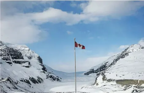  ?? THE CANADIAN PRESS FILES ?? The Canadian flag flies over the Columbia Icefields’ Athabasca Glacier in Jasper National Park. Nearly half the incidents of nudity that Parks Canada wardens dealt with in 2015 took place in Jasper National Park.