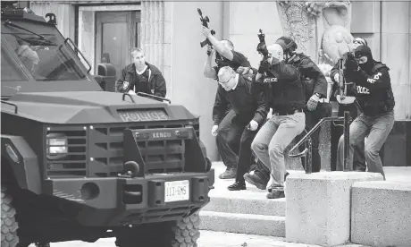  ?? ASHLEY FRASER ?? Police and RCMP remove a member of the military from the postal building on Sparks Street following the 2014 attack on Centre Block.