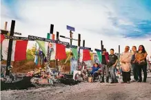  ?? Billy Calzada/staff file photo ?? People gather at a memorial last July on Quintana Road at the spot where 53 migrants in a tractor-trailer died in the summer heat during a human-smuggling attempt.