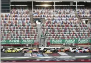  ?? GERRY BROOME — THE ASSOCIATED PRESS ?? Cars pass empty stands during a NASCAR Cup Series race at Charlotte Motor Speedway on May 28. The race was delayed by weather and not completed in time for this edition. For a recap, visit News-Herald.com.