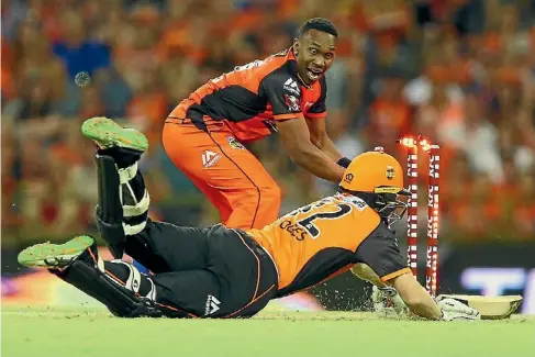  ?? GETTY IMAGES ?? Dwayne Bravo of the Melbourne Renegades celebrates running out Adam Voges of the Perth Scorchers during a recent Big Bash match.