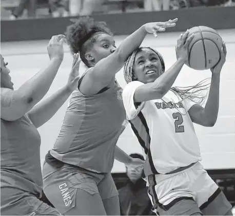  ?? Kin Man Hui/Staff photograph­er ?? Wagner’s LA Sneed (2) drives the lane against Sam Houston’s Yazmin Brown during their Class 5A second-round game Friday.