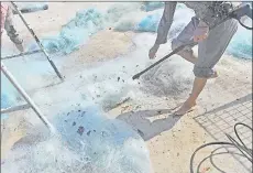  ??  ?? An employee at the Qualy Design factory cleaning discarded plastic fishing nets collected off the coast of Thailand.