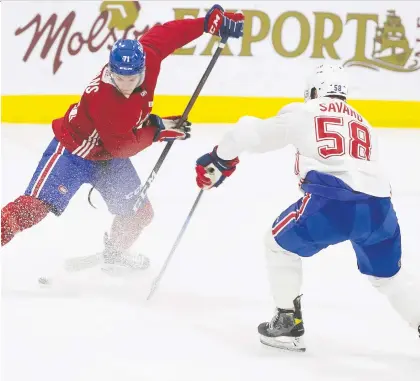  ?? PIERRE OBENDRAUF ?? Habs forward Jake Evans is met by defenceman David Savard during a training camp scrimmage on Friday. At 6-foot-2 and 233 pounds, Savard's strength is his physical game. “If I stay within my limit, play my game, I can help the team and have a positive impact,” he says.