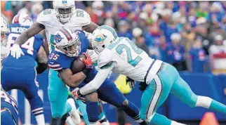  ?? ADRIAN KRAUS/AP ?? The Dolphins’ Isa Abdul-Quddus tackles Bills running back Mike Gillislee on Saturday in Orchard Park, N.Y.