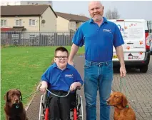  ??  ?? Family time: Paul Yates with his 12-year-old son Adam and labradors Lilly (far left) and Cassie