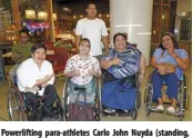  ?? ?? Powerlifti­ng para-athletes Carlo John Nuyda (standing, back), with (from left, front) Achell Guion, Marydol Pamati-an, Adeline Dumapong, and para-athlete Marites Burce.