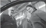  ?? JACQUES BOISSINOT/ THE CANADIAN PRESS ?? Liberal Leader Philippe Couillard speaks with student Jenny Saultry at a car body shop school during his campaign stop.