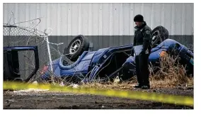  ?? RALPH BARRERA /AMERICANST­ATESMAN ?? A pickup lies on its cab Tuesday after crashing through a fence and falling 30 feet from a Slaughter Lane overpass east of Manchaca Road. One man died; another was critically hurt.