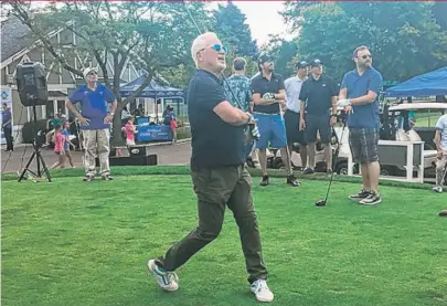  ??  ?? Joe Maddon admires his drive on the first hole at his second annual “Try Not to Suck” celebrity golf tourney.