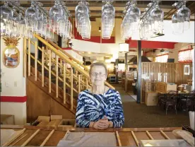  ?? The Maui News / COLLEEN UECHI photos ?? Kobe’s Japanese Steak House owner Martha Haleakala stands by the bar in the popular teppanyaki restaurant in Lahaina on Friday. After closing the restaurant Dec. 30 due to a lack of chefs, the family announced Wednesday that it would shut down for good due to staffing and the state of the economy.