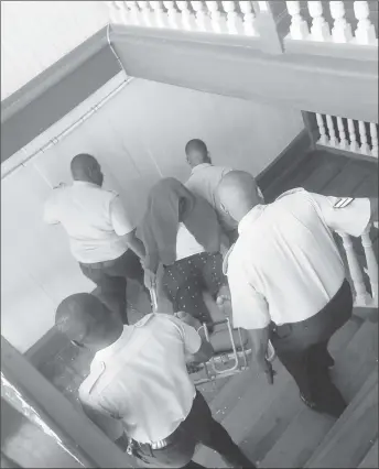  ??  ?? Leon Duncan being carried down the stairs of the Georgetown Magistrate­s’ Court by policemen.