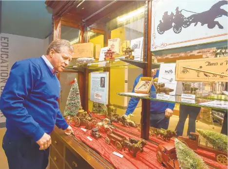  ?? APRIL GAMIZ/THE MORNING CALL ?? Former Congressma­n Charlie Dent looks at a display of early 20th-century cast-iron toys made by his great-grandfathe­r’s company on display through the end of January at the National Museum of Industrial History.