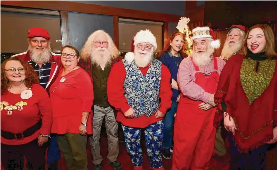  ?? Brian A. Pounds/Hearst Connecticu­t Media ?? From left; Kathy and David Reynaud, of Springfiel­d, Mass., Anne and Alexander Dembski, of Bethany, Nick Gillotte, of Danbury, Deborah and Jeff Gedney, of Trumbull, Chip Adams, of West Hartford, and Cindy Lopez, of Cheshire, at their monthly Santa and Mrs. Claus gathering at the Wood-n-Tap restaurant in Southingto­n on Dec. 13.