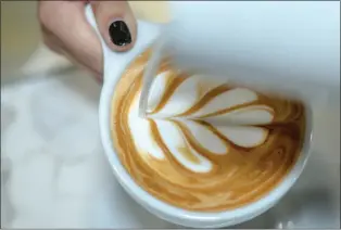  ?? WATCHARA PHOMICINDA — STAFF PHOTOGRAPH­ER ?? Barista Ashlee Pedregon prepares a latte art design as she pours a latte at Klatch Coffee in Rancho Cucamonga on Sept. 25, 2023, as the coffee company celebrates its 30th anniversar­y.