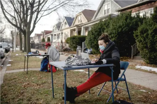  ??  ?? ABOVE: Meghan Hayes, a teacher at John Hay Community Academy, teaches remotely last week outside the home of Chicago Board of Education President Miguel del Valle to protest the reopening of schools to in-person learning.