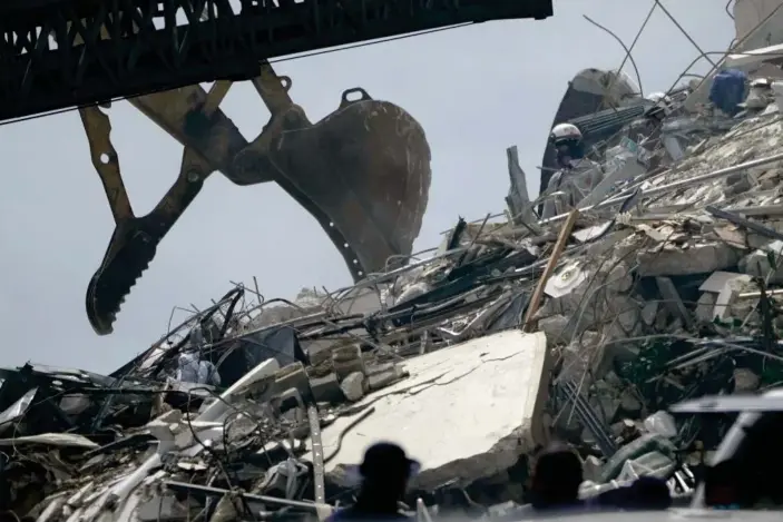  ?? Photograph: Lynne Sladky/AP ?? Search and rescue workers go through rubble hoping to detect any sounds coming from survivors.