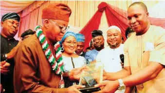  ??  ?? Osun State Governor, Mr. Adegboyega Oyetola; his wife, Kafayat; Chairman, Trade Union Congress Osun State Chapter, Comrade Adebowake Adekola and Chairman, Nigeria Labour Congres, Comrade Jacob Adekomi, decorating Governor Oyetola for his andmark achievemen­ts in the state, as part of activities marking year 2021 Workers Day, at the Government House, Osogbo