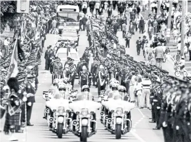  ?? TIBOR KOLLEY THE GLOBE AND MAIL FILE PHOTO ?? The police funeral for Const. Todd Baylis was the largest in Canadian history. More than 10,000 officers attended.