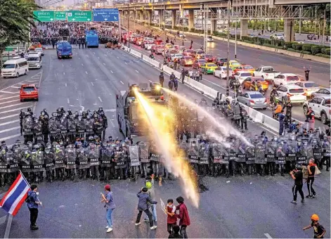  ?? Photo — AFP ?? A water cannon truck is deployed by the police to disperse pro-democracy protesters marching toward the residence of Prayut Chan-O-Cha in Bangkok,