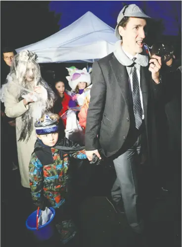 ?? CHRIS WATTIE / REUTERS FILES ?? Prime Minister Justin Trudeau, participat­ing in Halloween festivitie­s with his children in 2018, said his family will not be going door to door later this month.