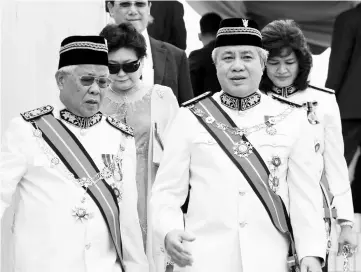  ??  ?? Manyin (left) speaks to newly appointed Deputy Chief Minister Datuk Amar Awang Tengah Ali Hasan at the end of the opening ceremony. — Photo by Chimon Upon