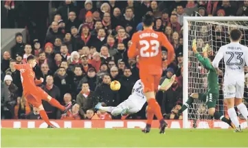  ??  ?? Liverpool’s Ben Woodburn scores against Leeds United during their English League Cup quarter-final match at Anfield. — AFP photo