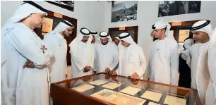  ?? Supplied photo ?? Officials glance through customs documents from the bygone era of Dubai. —