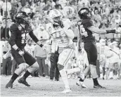  ?? Mark Humphrey / Associated Press ?? Purdue’s Mitchell Fineran, right, kicked four field goals Thursday, including the game-winner.