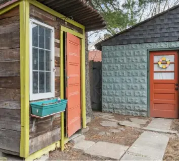  ?? ?? The colorful shed holds garden tools and other equipment.