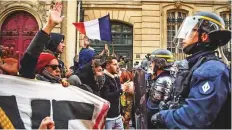  ?? AFP ?? People face riot police as they try to demonstrat­e near the Presidenti­al Elysee palace in Paris on Saturday.