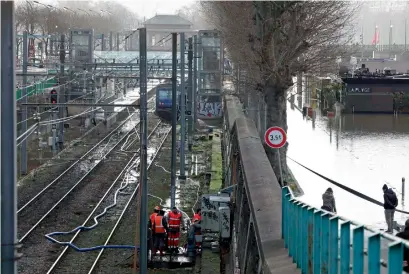  ?? AFP ?? Workers pump water from the Javel railway station, flooded due to the high level of the Seine River in Paris, on Saturday. —