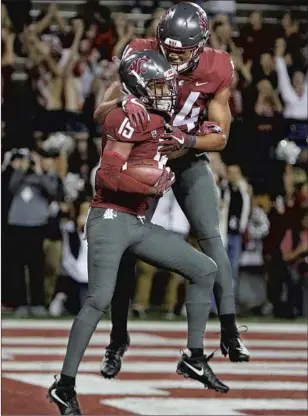  ?? Young Kwak Associated Press ?? KASSIDY WOODS, rear, with Washington State teammate Robert Lewis in 2018, transferre­d to Northern Colorado. Of schools playing this year, Woods said, “It’s really disgusting.”