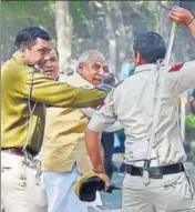  ?? PTI ?? INLD leader Ashok Arora’s bodyguard tries to save himself during lathicharg­e by the police in New Delhi.