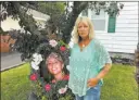  ?? Mary Esch ?? The Associated Press Patty Farrell beside a memorial to her daughter in front of her Colonie, N.Y., home on Friday.