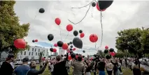  ?? PHOTO: GEORGE HEARD/FAIRFAX NZ ?? Balloons are released at the CTV Memorial site during the 6th anniversar­y of the Christchur­ch earthquake.