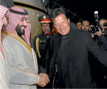  ?? AP ?? Pakistani Prime Minister Imran Khan, right, greets Saudi Arabia’s Crown Prince Mohammed bin Salman, left, upon his arrival at Nur Khan airbase in Rawalpindi. Saudi Arabia’s powerful Crown Prince Mohammed bin Salman began his four-day regional visit yesterday.