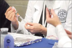  ?? Ned Gerard / Hearst Connecticu­t Media ?? A nurse fills a syringe with a shot of COVID-19 vaccine at the vaccinatio­n clinic in Fairfield on Jan. 27. Vaccine clinics for educators are expected to start Monday.