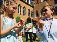  ?? AP/Tyler Morning Telegraph/SARAH A. MILLER ?? Cambridge Tennant (left), 8, and Jackson Pope, 7, talk Sunday as they feed watermelon to newly released butterflie­s at Marvin United Methodist Church in Tyler, Texas. The church released the butterflie­s as part of its Easter celebratio­n.