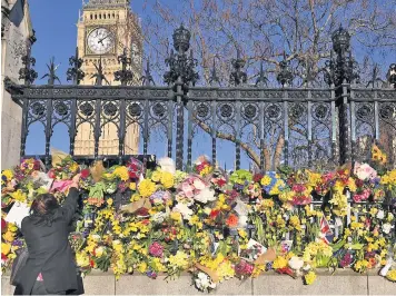  ??  ?? Floral tributes in Parliament Square yesterday in memory of the victims of Wednesday’s attack, including Pc Keith Palmer, below