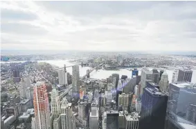  ?? Mark Lennihan, Associated Press file ?? New York’s Financial District, foreground, the Brooklyn Bridge and East River, center, and in the distance Brooklyn are seen in 2015.