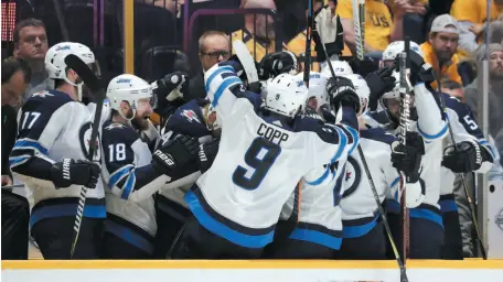  ?? AP PHOTO/CP PHOTO ?? ABOVE: Winnipeg Jets players celebrate after a goal against the Nashville Predators late in the third period of Thursday night’s game in Nashville. The Jets won 5-1. BELOW: Jets fans celebrate at a viewing party in Winnipeg.