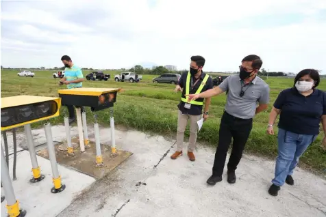  ?? (CIAC-CCO) ?? AIRFIELD LIGHTING SYSTEM. Officials of Clark Internatio­nal Airport Corporatio­n President and Chief Executive Officer Aaron N. Aquino and Vice President for Operations Irish “IC” Calaguas inspected recently Clark airport's upgraded runway and taxiway lighting and signages.